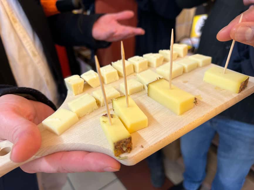 Zurich: Food Tour of 8+ Tastings with Cheeses & Chocolates - Fondue bites dipped in Kirsch, then historic gin at a bottle shop